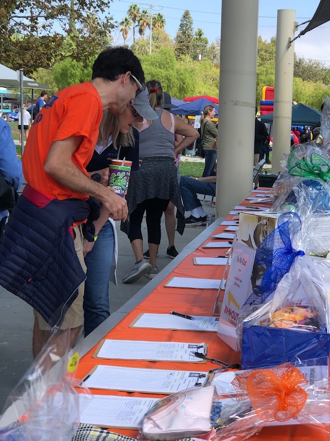 A man looks at silent auction items