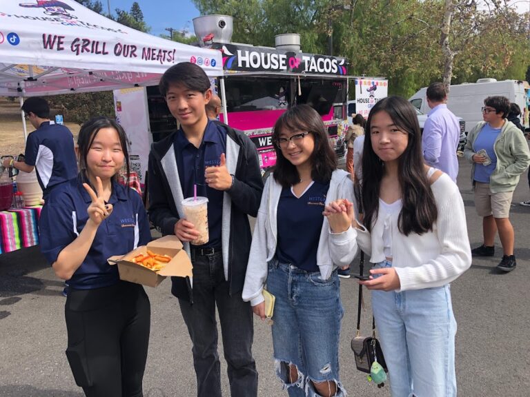 student volunteers are taking a break to try the food